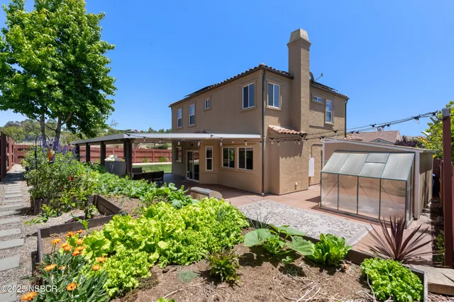 a roof deck with table and chairs