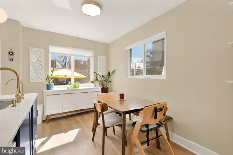 a kitchen with a table and chairs in it