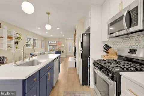 a kitchen with stainless steel appliances granite countertop a stove and a sink