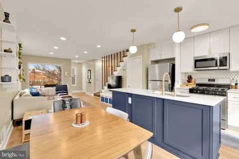 a large kitchen with kitchen island a large island in the center