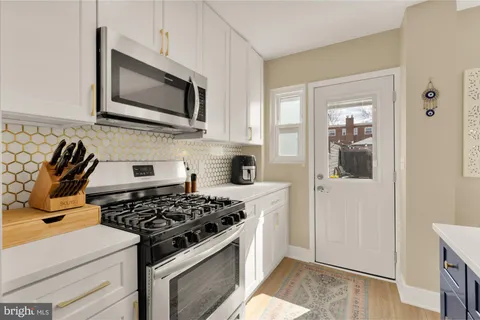 a kitchen with stainless steel appliances a stove a microwave and cabinets