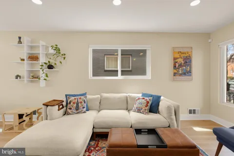 a living room with furniture and painting on the wall