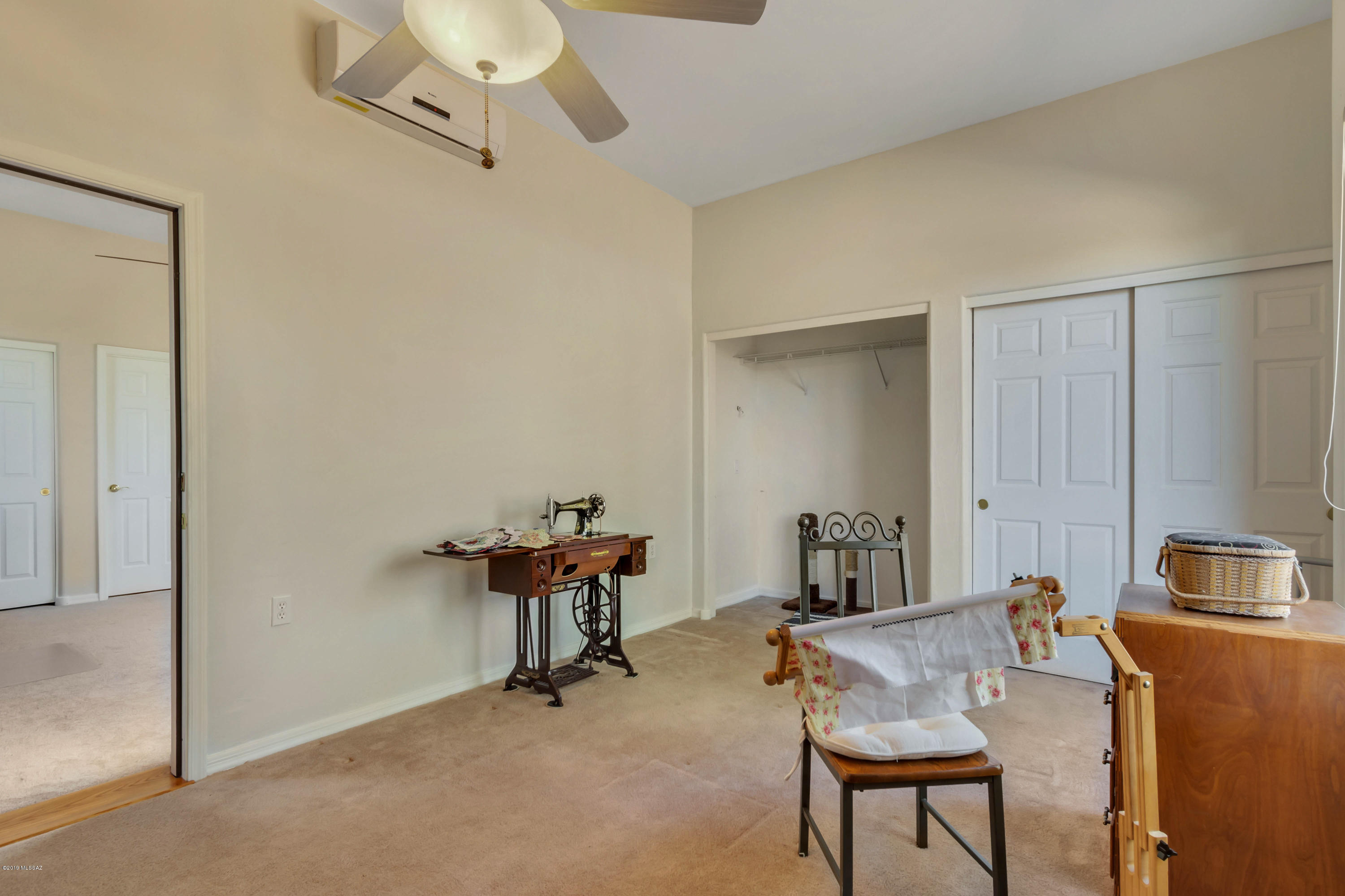 12682 North Spirit Mountain Road Oro Valley, AZ 85755 - Photo 40 of 40 a room with chandelier fan and a wooden floor