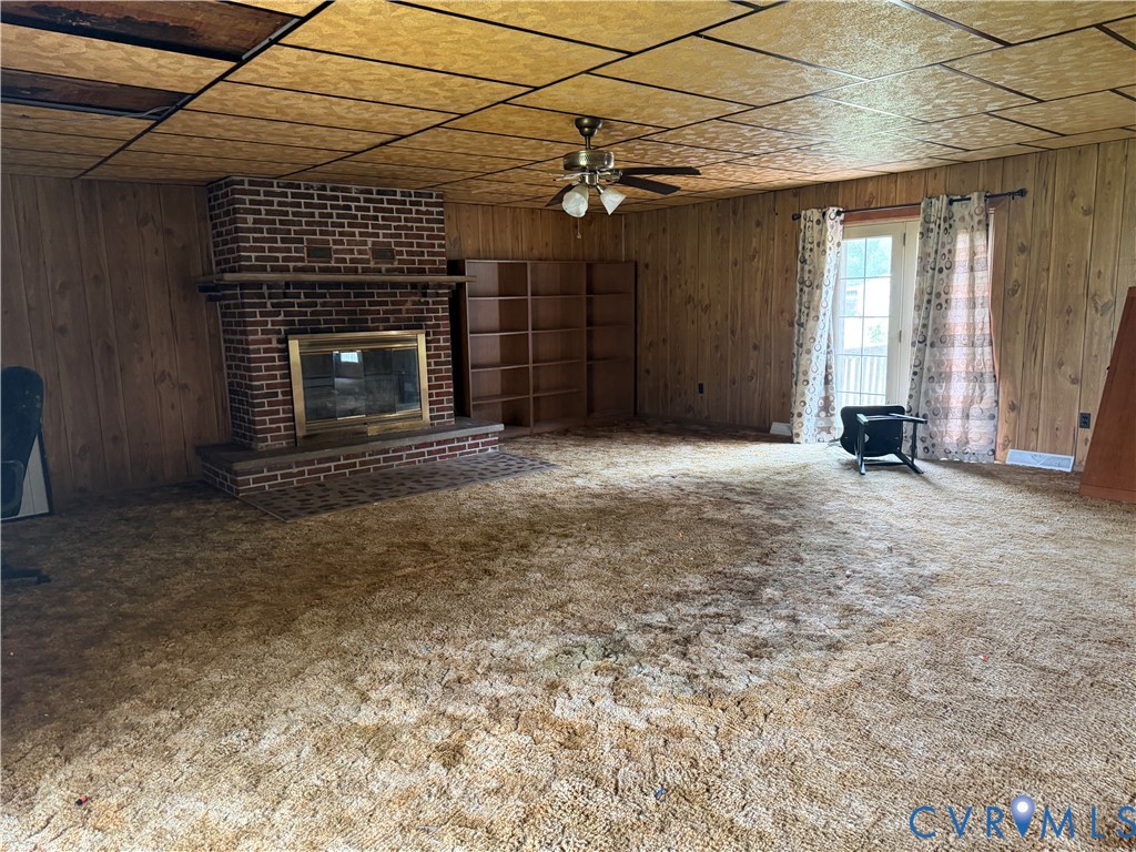 6509 Hines Road Disputanta, VA 23842 - Photo 11 of 22 Brick fireplace with a brass firebox insert and a