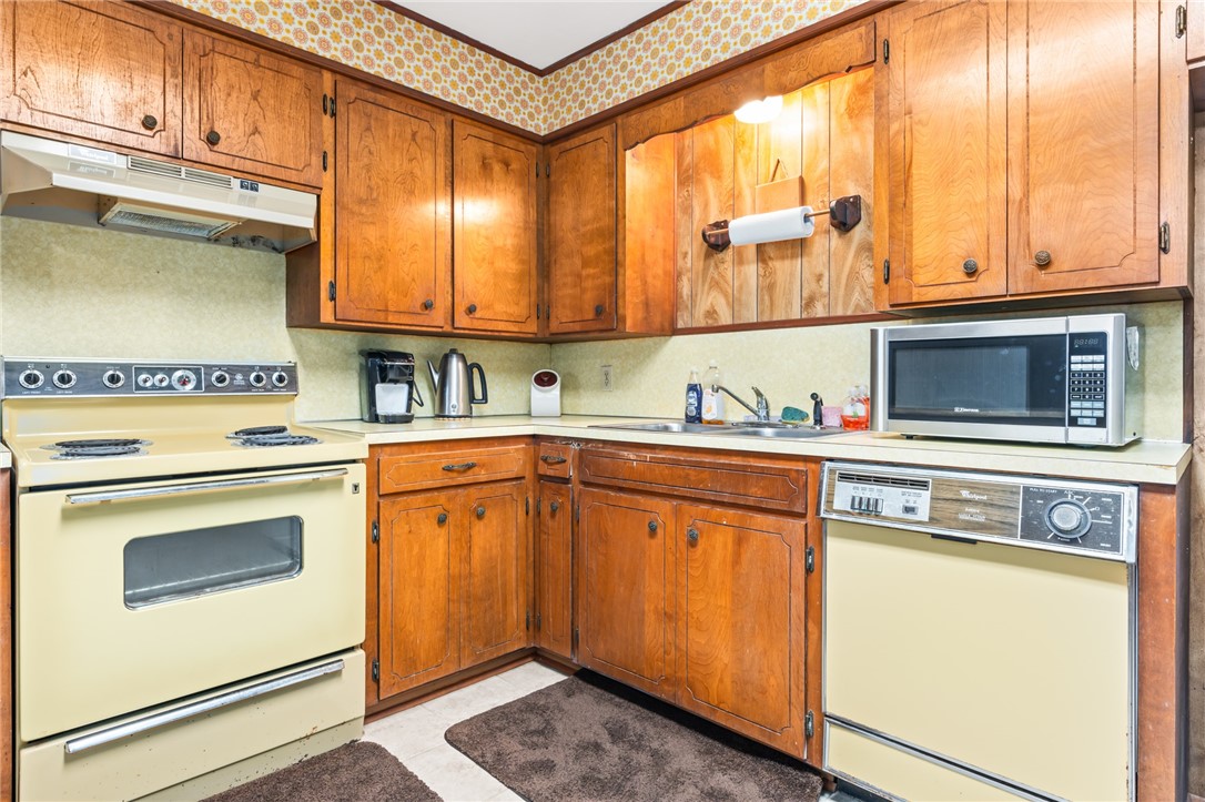 654 Lcr 654 Road Thornton, TX 76687 - Photo 49 of 64 a kitchen with stainless steel appliances granite countertop a sink and cabinets with wooden floor