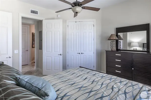 a bathroom with a granite countertop sink toilet and mirror