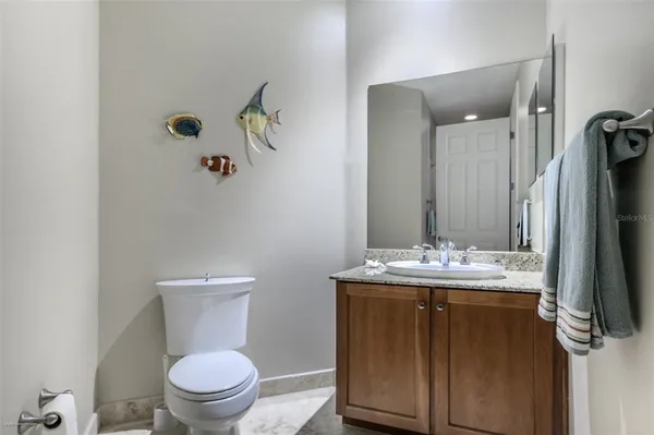 a kitchen with stainless steel appliances granite countertop a sink a stove and a wooden cabinets