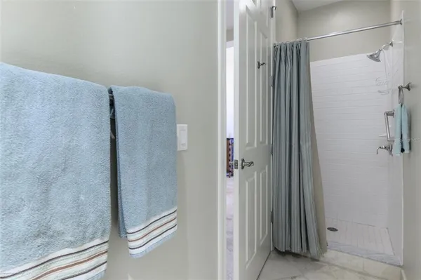 a kitchen with stainless steel appliances granite countertop a sink a refrigerator and a granite counter tops