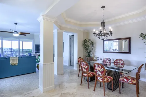 a living room with furniture and a chandelier