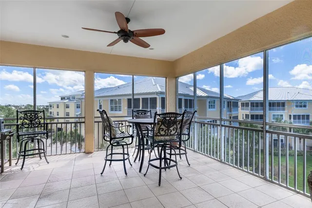 a living room with furniture and a view of kitchen