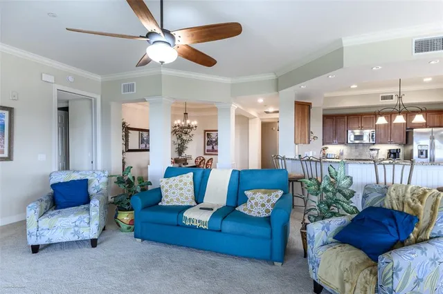 a bedroom with a bed a couch and a large window