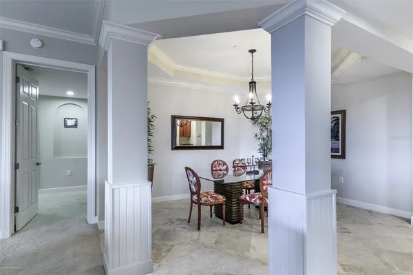 a living room with furniture a ceiling fan and a large window