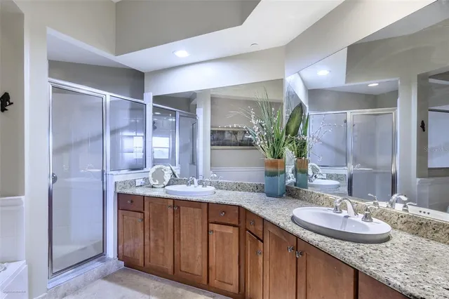 a living room with furniture a ceiling fan and a large window