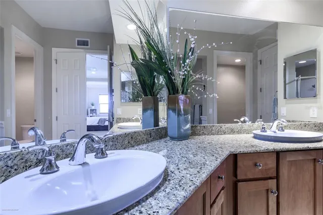 a front view of a house with a garden and plants