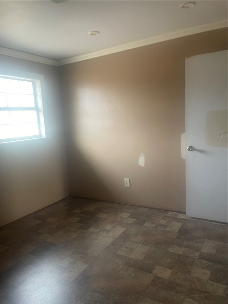 215 West 4th Street Alice, TX 78332 - Photo 13 of 14 an empty room with a empty space and window