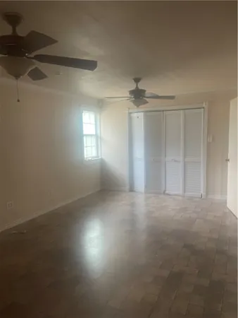 an empty room with a empty space and windows