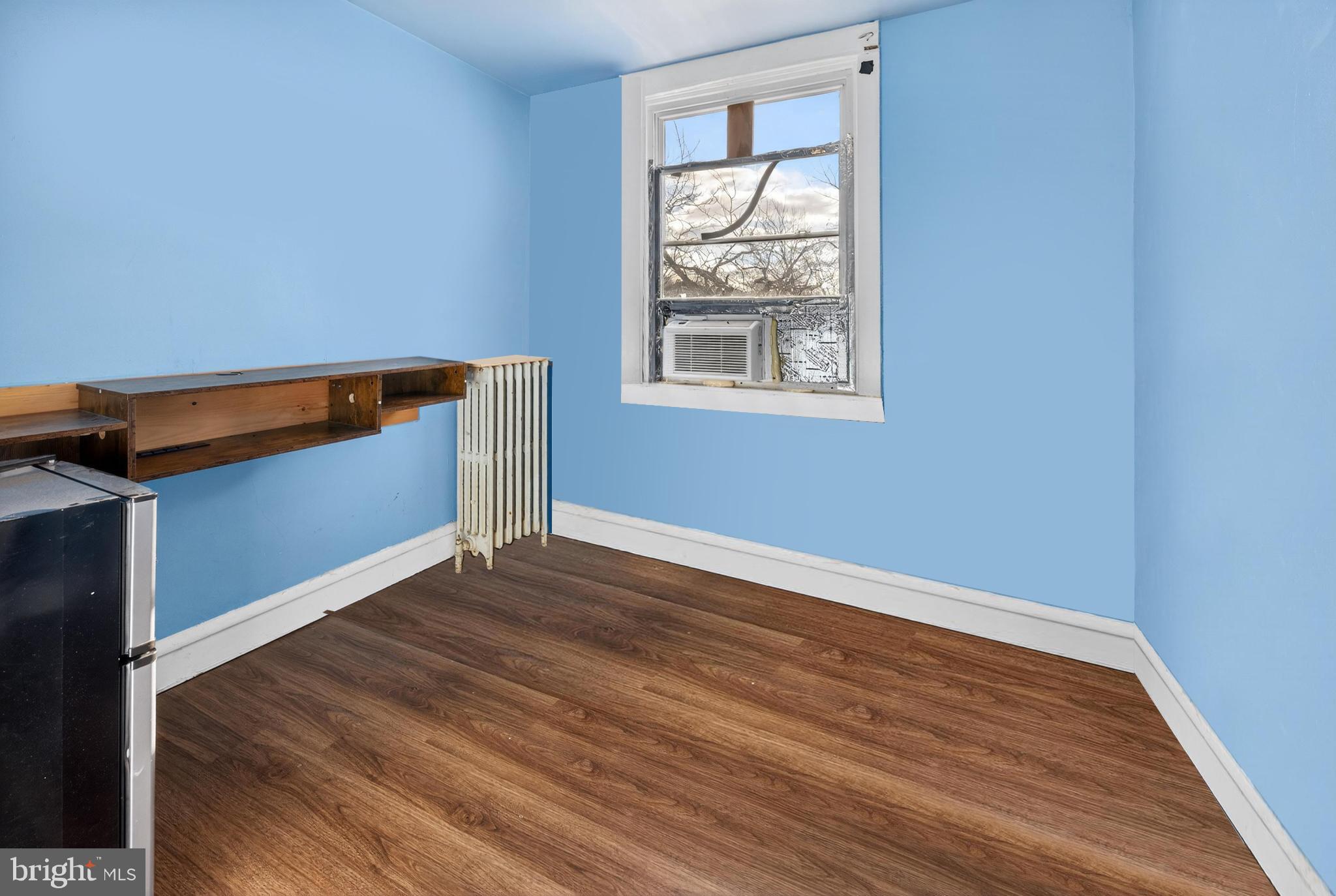 1330 South Merrimac Road Camden, NJ 08104 - Photo 11 of 17 wooden floor in an empty room with a window
