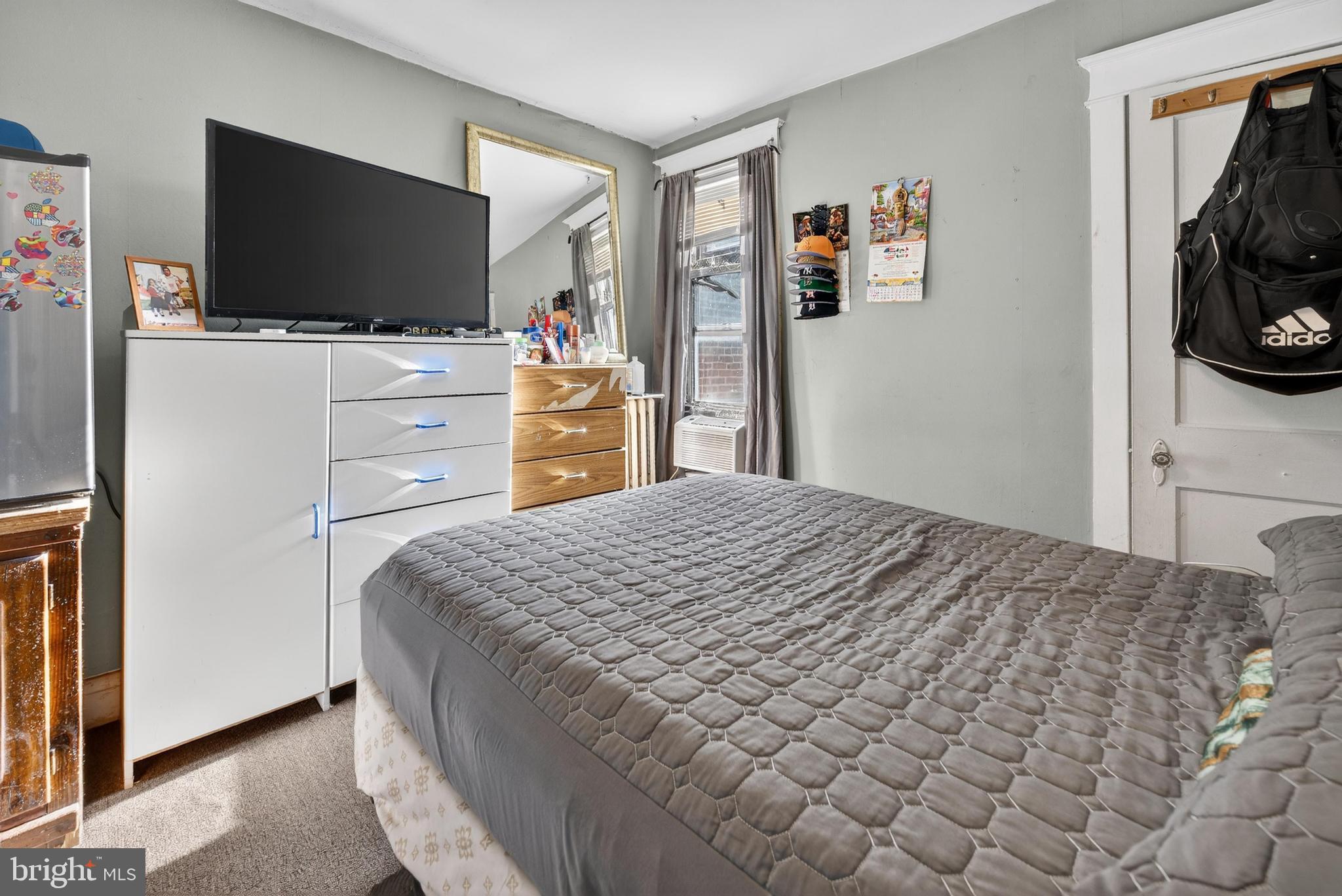 1330 South Merrimac Road Camden, NJ 08104 - Photo 13 of 17 a bedroom with a bed and a flat screen tv