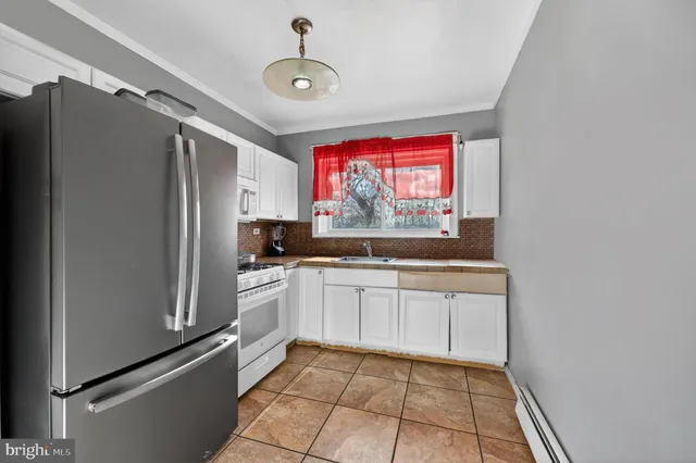 a kitchen with stainless steel appliances a refrigerator and a stove