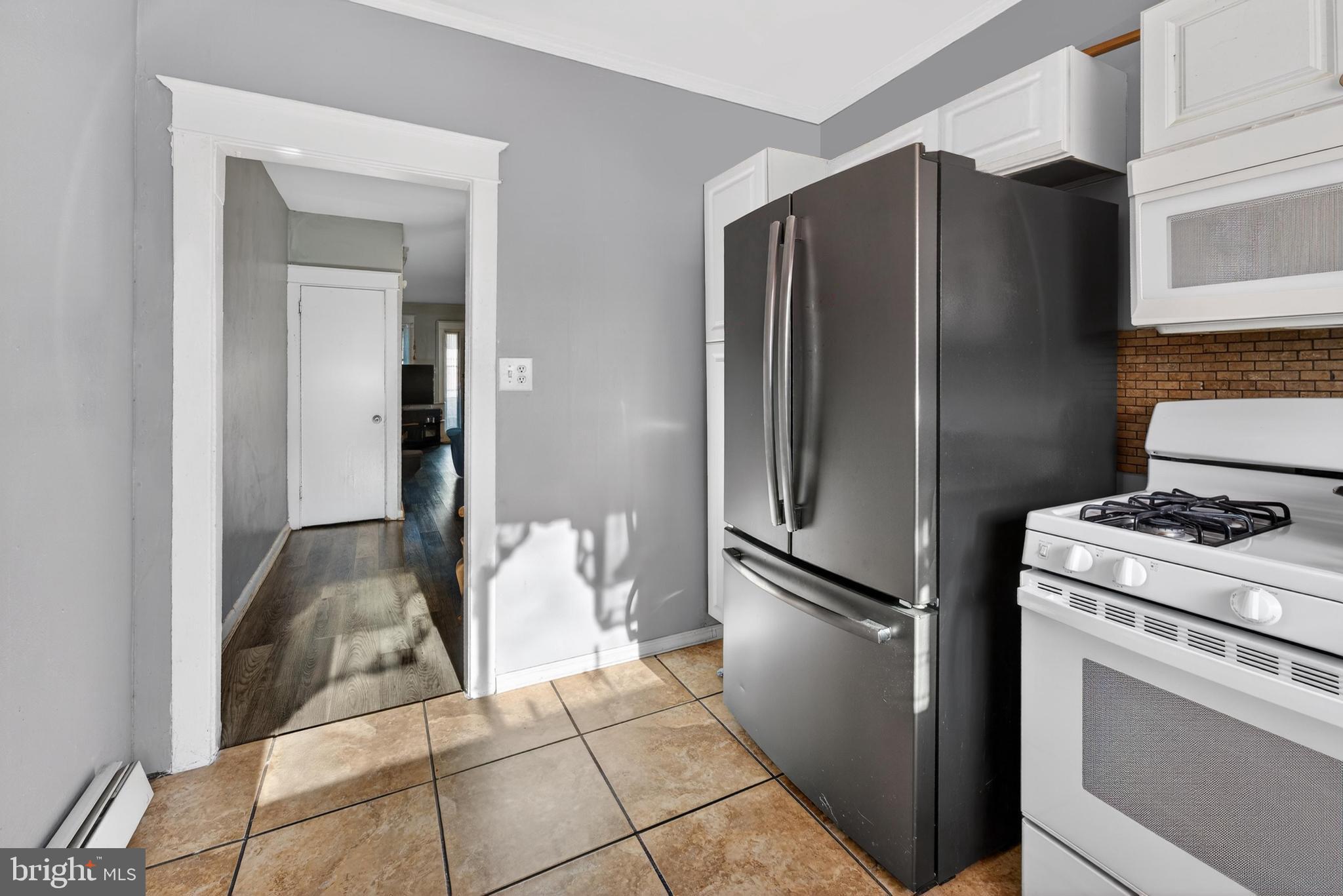 1330 South Merrimac Road Camden, NJ 08104 - Photo 8 of 17 a kitchen with a refrigerator and a stove