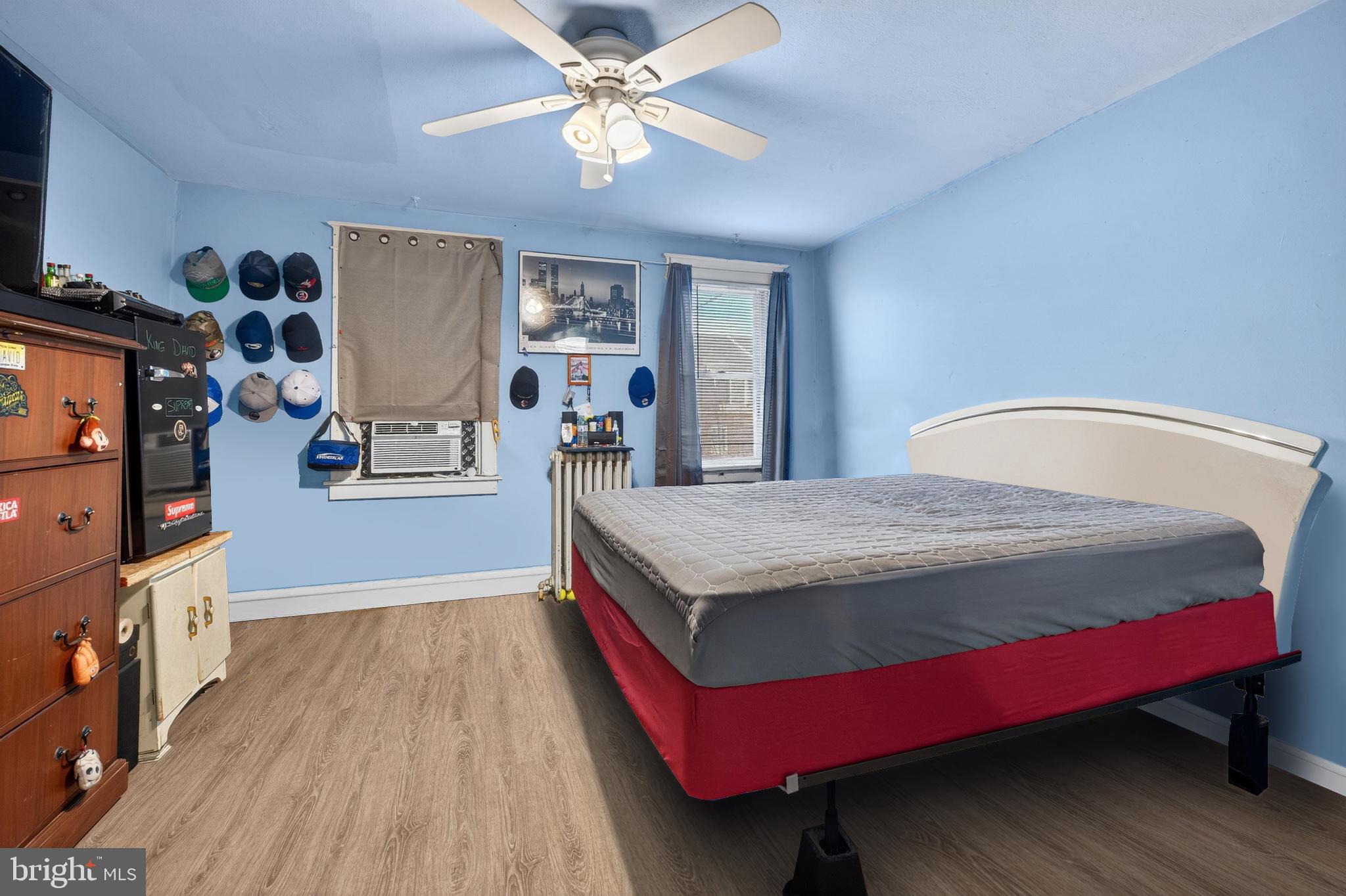 1330 South Merrimac Road Camden, NJ 08104 - Photo 9 of 17 a bedroom with a bed and a flat screen tv