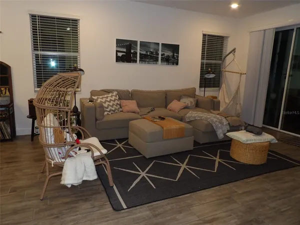 a living room with furniture and wooden floor