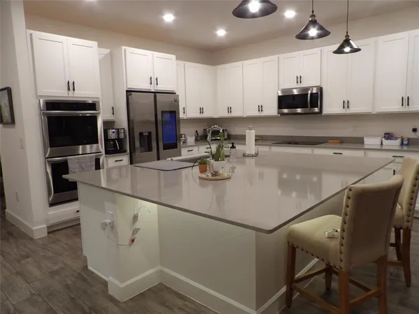 a kitchen with a sink a microwave and refrigerator