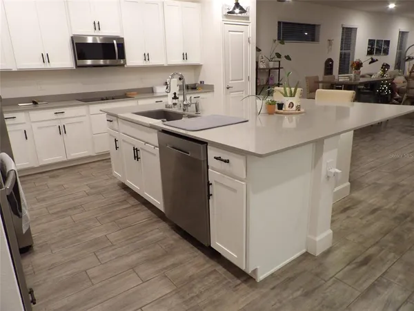 a kitchen with stainless steel appliances granite countertop a sink stove and cabinets