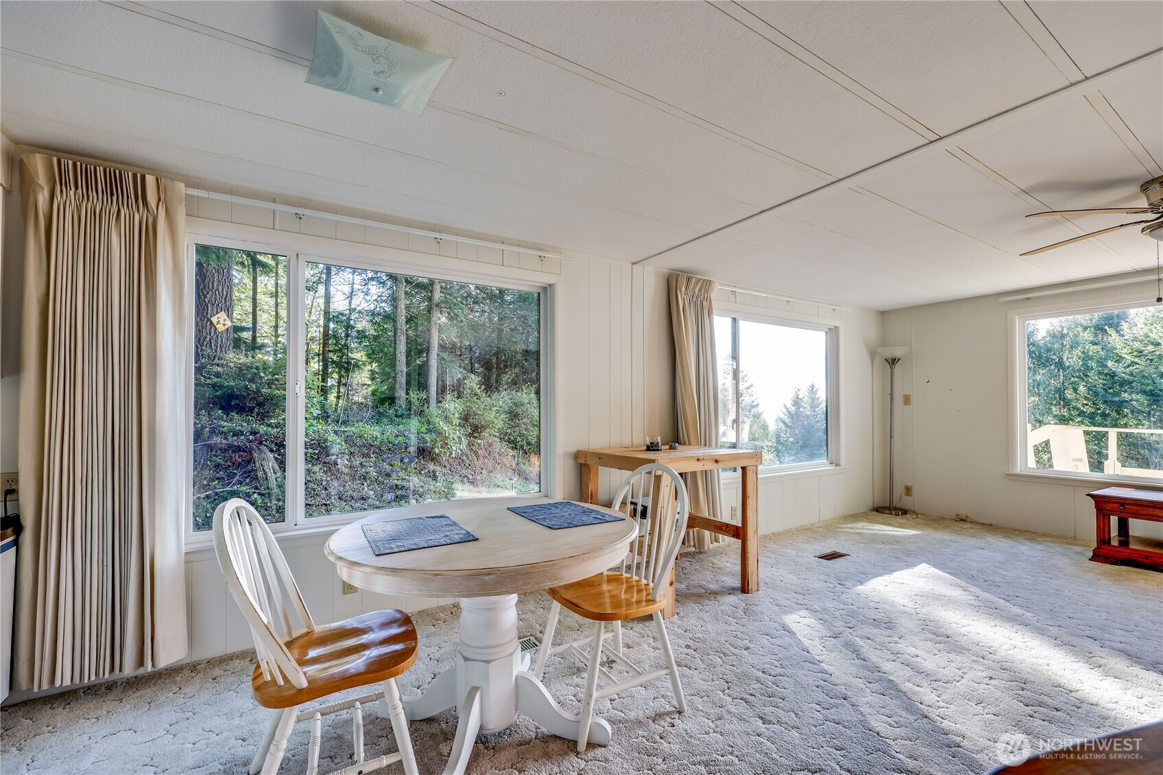 170 Cirque Drive Brinnon, WA 98320 - Photo 11 of 24 a dining room with furniture a chandelier and wooden floor