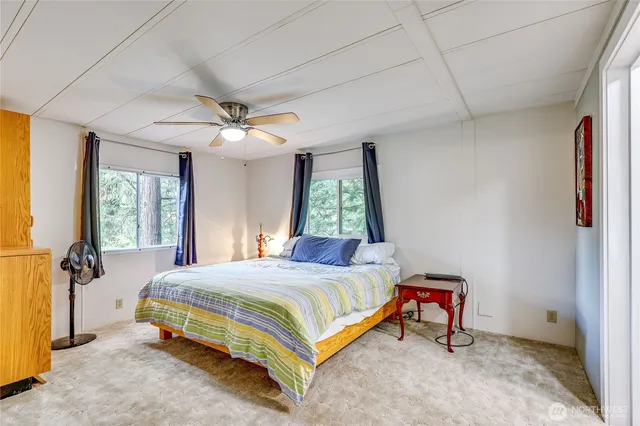 a bedroom with a large bed and a large window