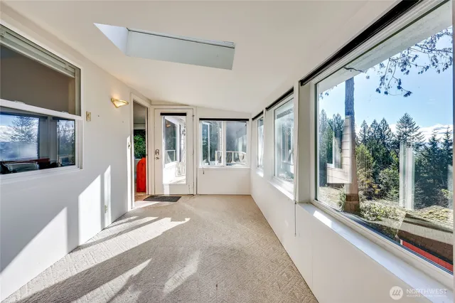 a view of a patio with a table and chairs and floor to ceiling window