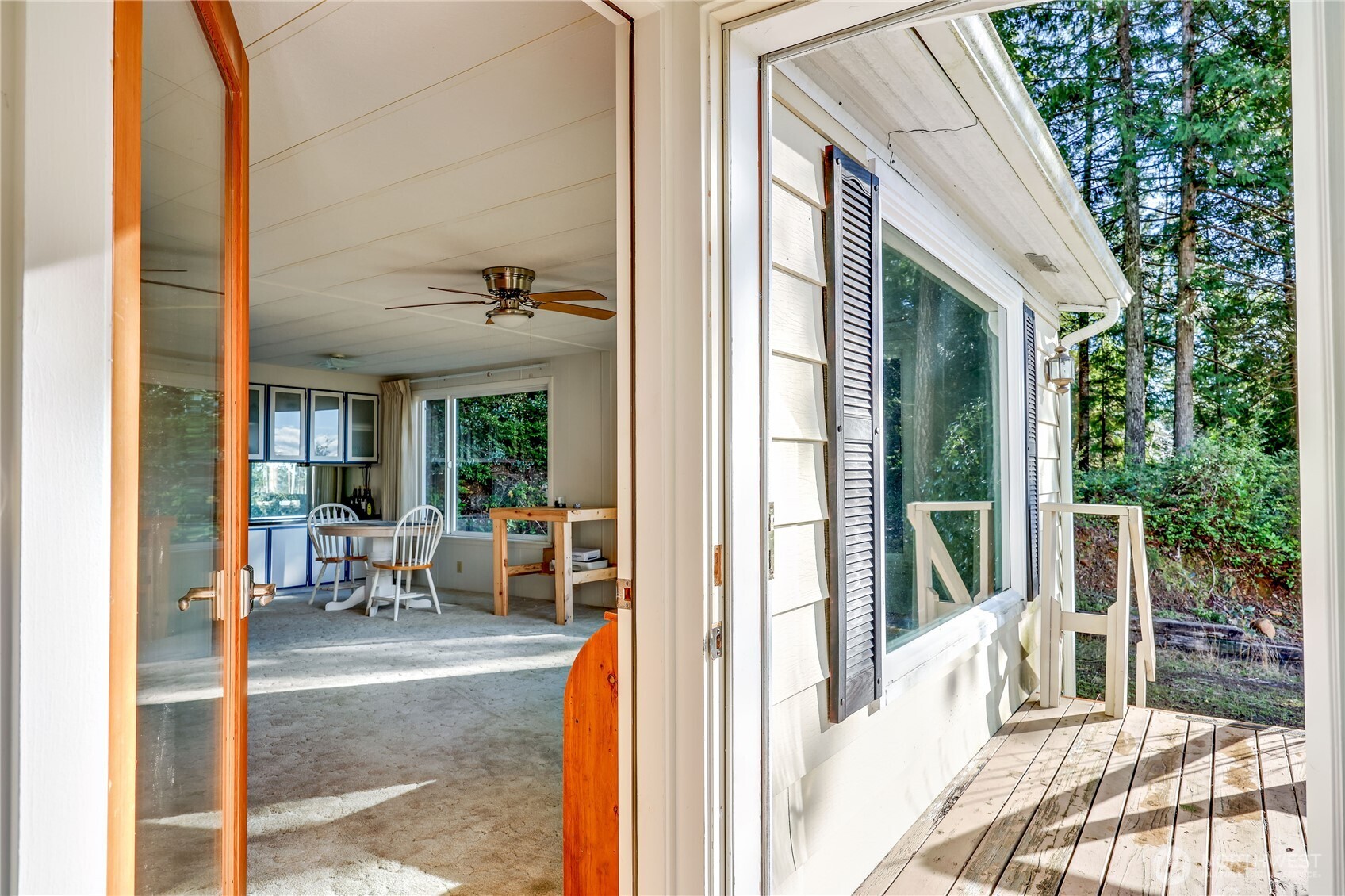 170 Cirque Drive Brinnon, WA 98320 - Photo 8 of 24 a view of a patio with a table and chairs and floor to ceiling window