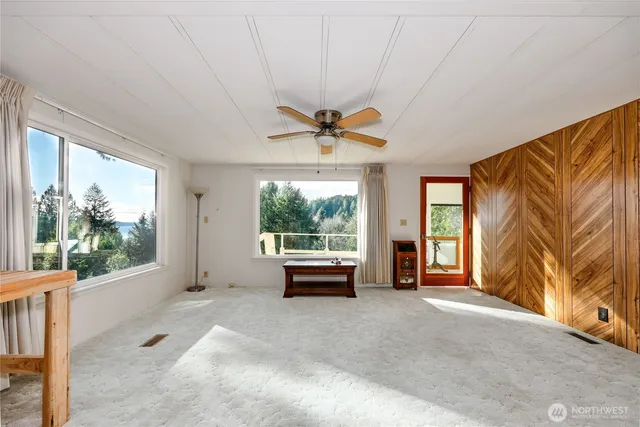 a dining room with furniture a chandelier and wooden floor