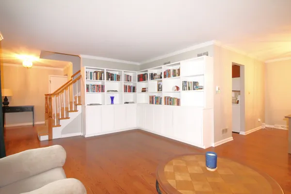 a living room with furniture and a book shelf