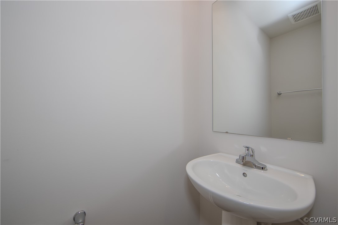 5357 Canterbury Ridge Richmond, VA 23224 - Photo 14 of 14 a bathroom with a sink and a mirror