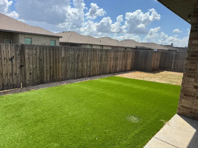 a view of a backyard with table and chairs