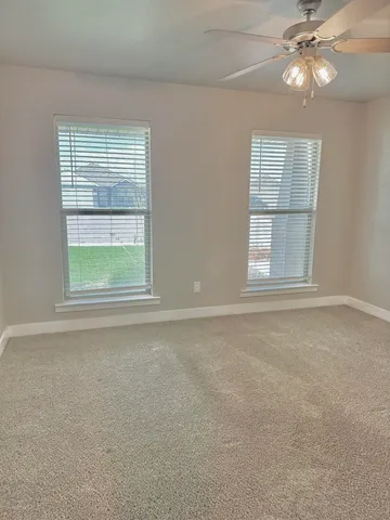 an empty room with a window and fireplace