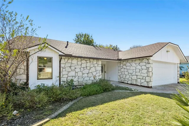 a view of a house with a yard and garage