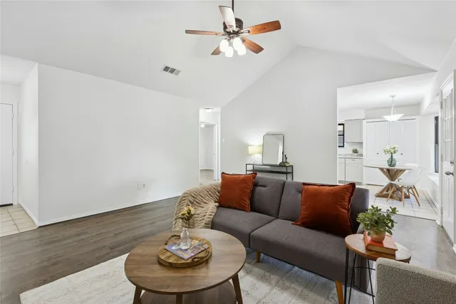 a living room with furniture and a wooden floor