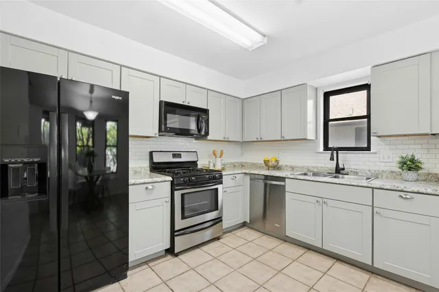 a kitchen with a sink stove and refrigerator