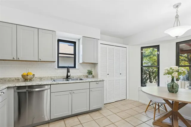 a kitchen with a sink cabinets and window
