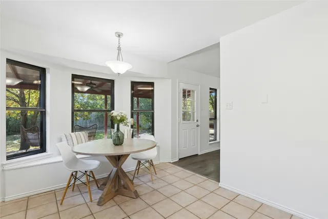 a dining room with furniture and window