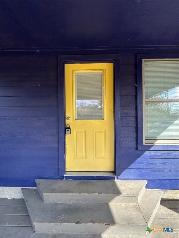 1017 West Nueces Street Victoria, TX 77901 - Photo 12 of 31 a view of a door and wooden floor in a room