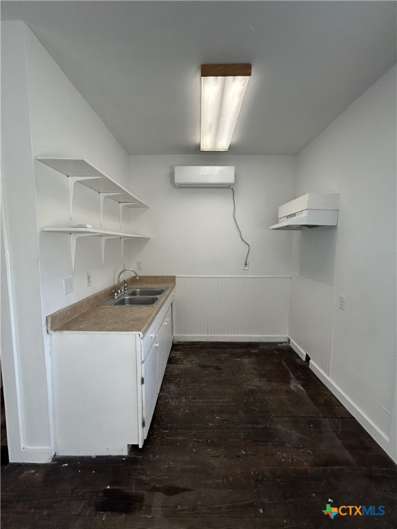 1017 West Nueces Street Victoria, TX 77901 - Photo 13 of 31 a kitchen with a sink a stove and cabinets