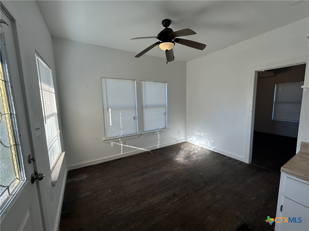1017 West Nueces Street Victoria, TX 77901 - Photo 14 of 31 wooden floor in an empty room with a window