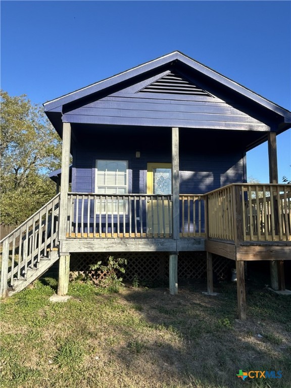 1017 West Nueces Street Victoria, TX 77901 - Photo 22 of 31 a view of a house with wooden deck and furniture