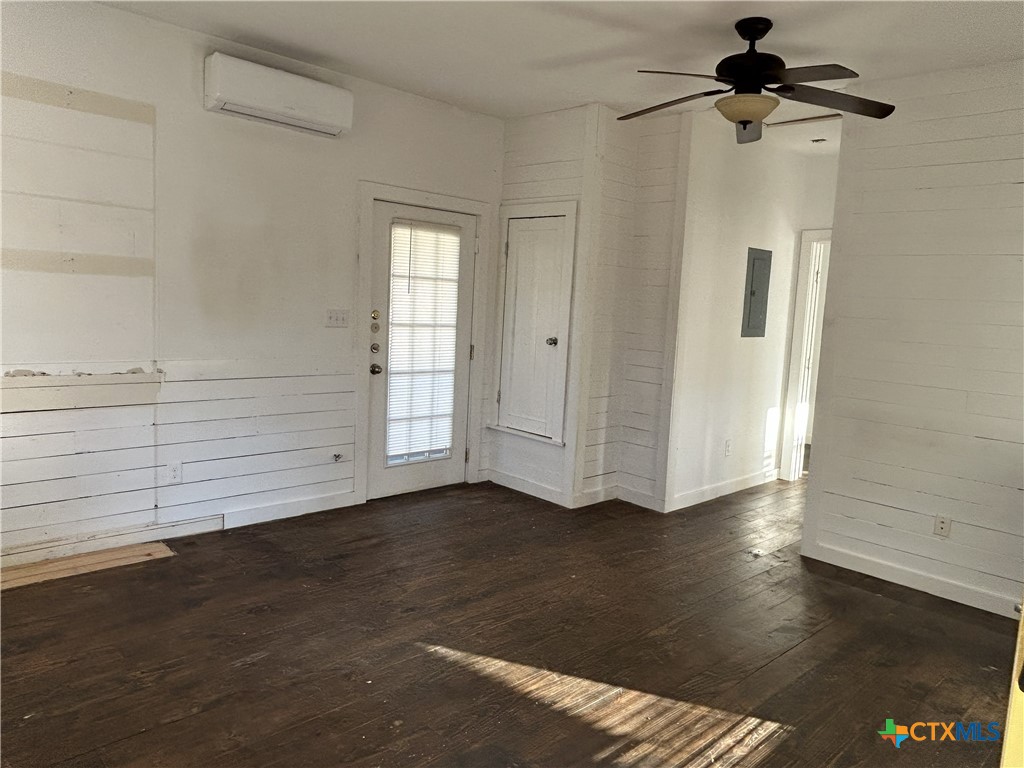 1017 West Nueces Street Victoria, TX 77901 - Photo 25 of 31 a view of an empty room with wooden floor and a window