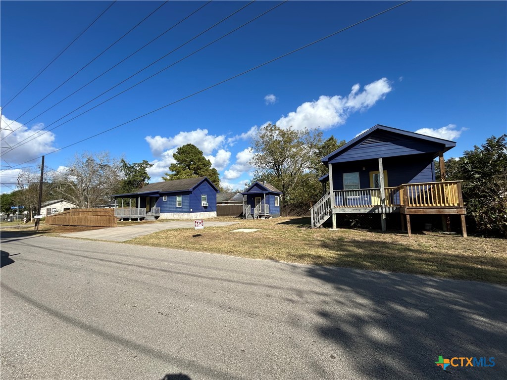 1017 West Nueces Street Victoria, TX 77901 - Photo 5 of 31 a view of a house with a yard next to a road