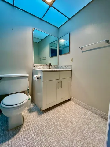 a bathroom with a sink toilet and mirror