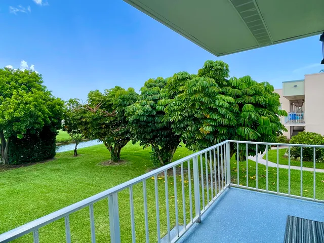 a view of a deck with a big yard